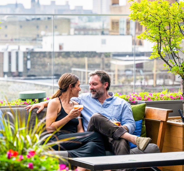 Couple sitting at a rooftop lounge