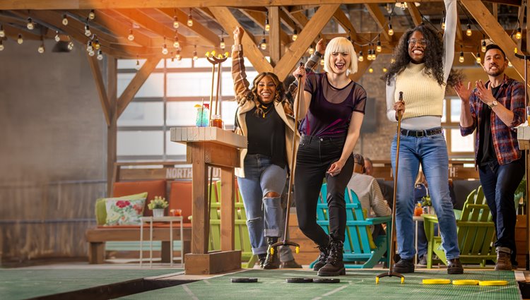 096 Friends Celebrate While Playing Shuffleboard