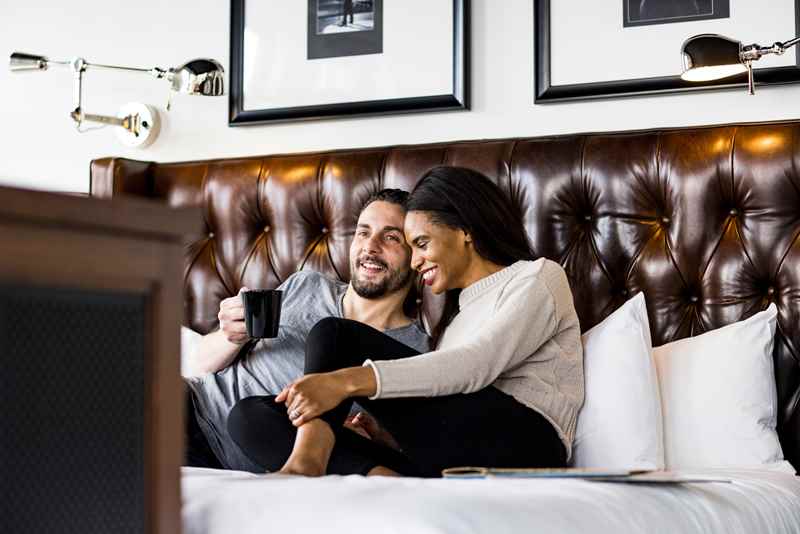 couple hangs out in hotel room