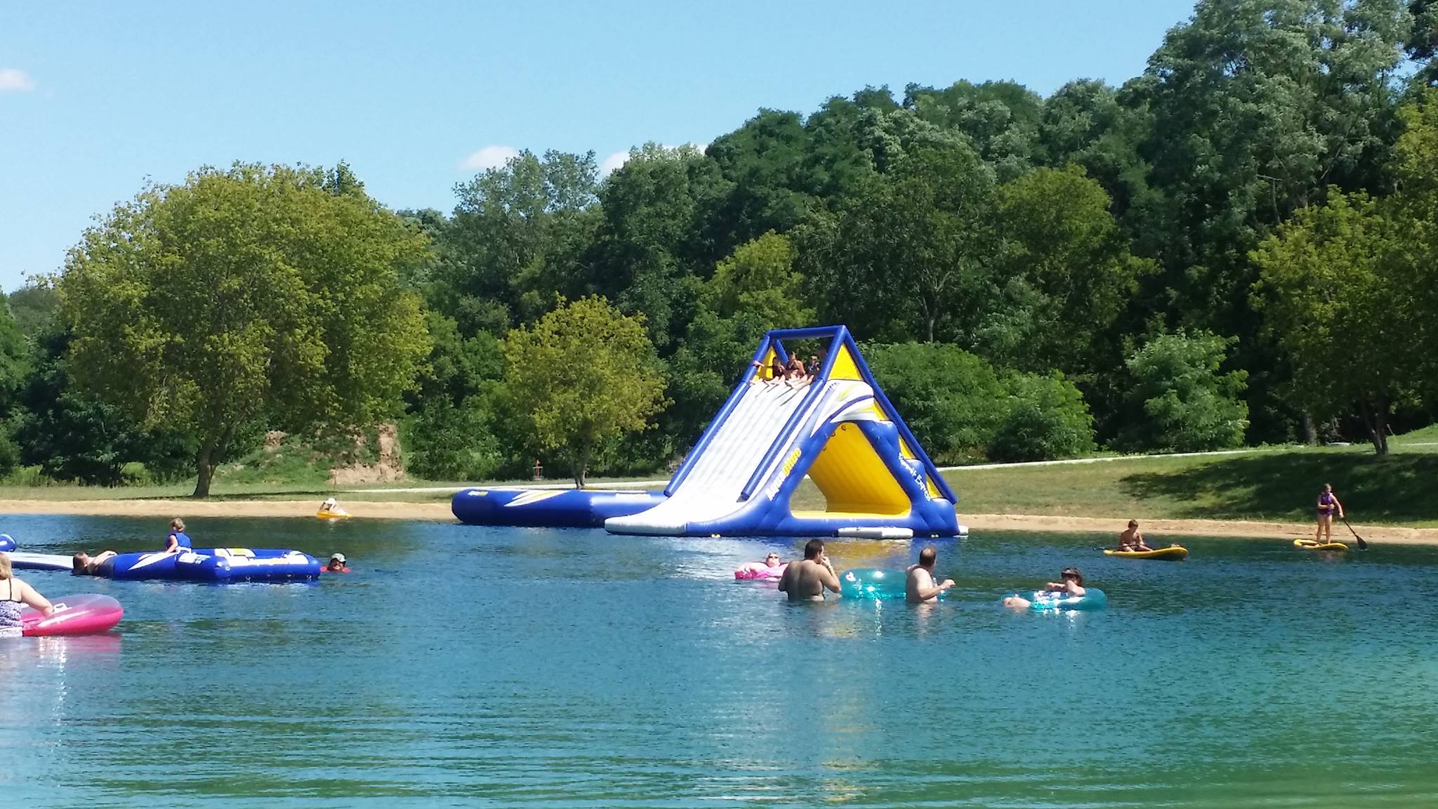 https://www.travelwisconsin.com/uploads/places/ba/ba8726b4-4caa-4ade-8a07-433b8c741dbd-1611158589852-swim-pond-with-inflatibles.jpg